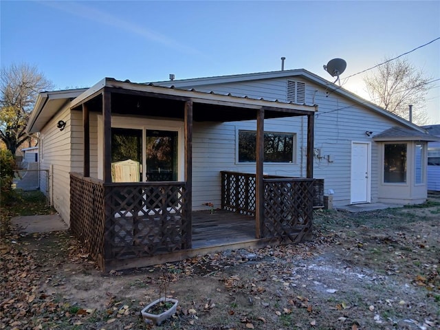 back of property with a wooden deck