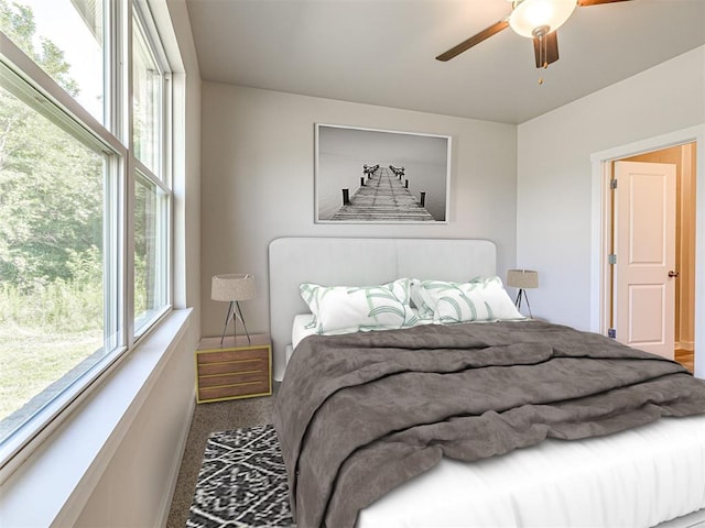 bedroom with ceiling fan and carpet floors