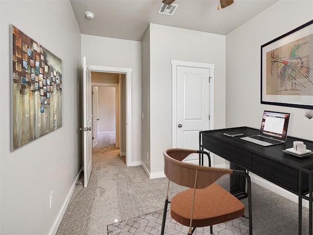 carpeted office space with ceiling fan