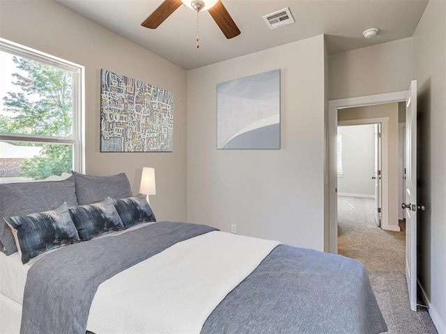 bedroom with light colored carpet and ceiling fan