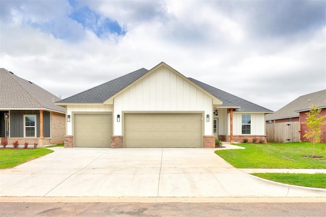 view of front facade with a front yard and a garage