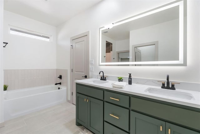 bathroom with tile patterned flooring, a bath, and vanity