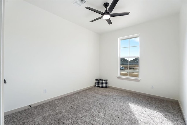 spare room featuring ceiling fan and carpet