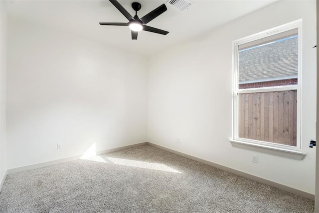 carpeted spare room with ceiling fan