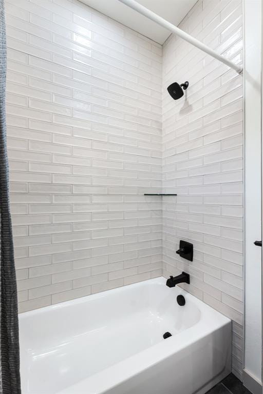 bathroom featuring tile patterned flooring and shower / bathtub combination with curtain