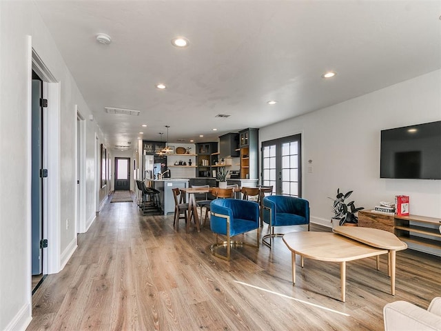 living room with light hardwood / wood-style floors and french doors