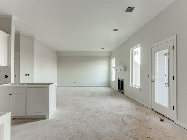 unfurnished living room with crown molding