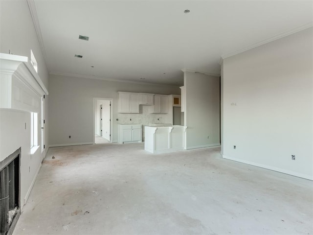 unfurnished living room featuring crown molding