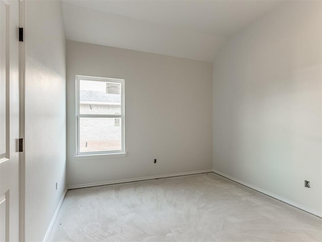 unfurnished room featuring vaulted ceiling