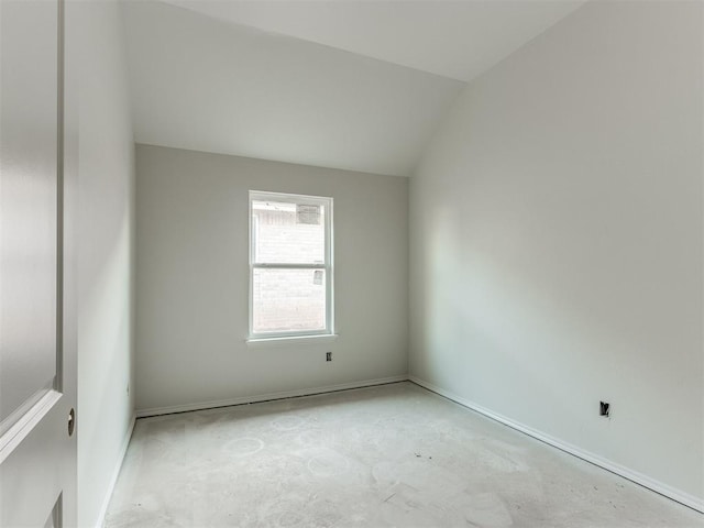 empty room featuring vaulted ceiling