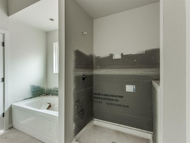 bathroom with a tub to relax in