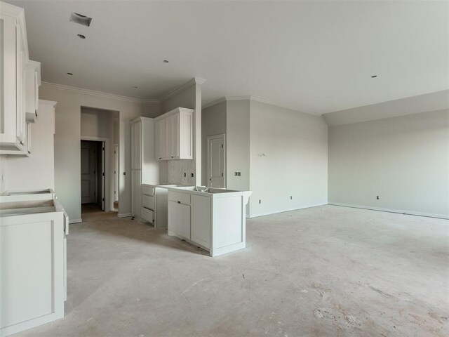 3305 NW 178th Ter, Edmond, OK 73012 - kitchen with unfinished concrete flooring, white cabinets, baseboards, open floor plan, and crown molding