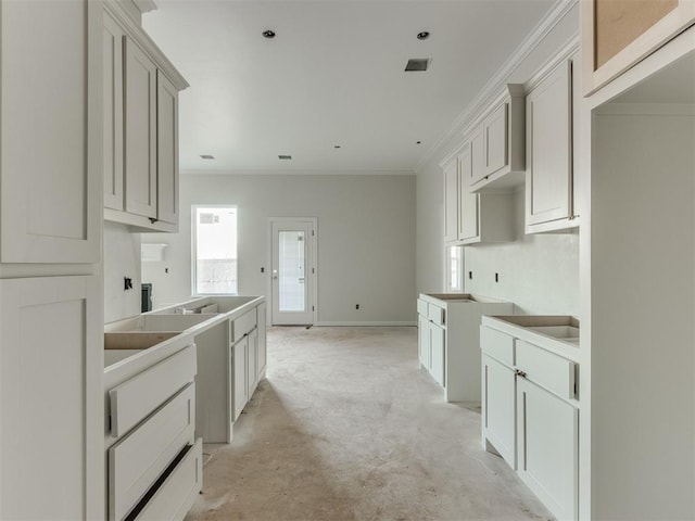 3305 NW 178th Ter, Edmond, OK 73012 - kitchen featuring ornamental molding, unfinished concrete flooring, and baseboards