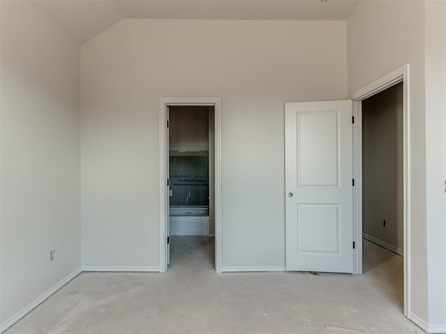 3305 NW 178th Ter, Edmond, OK 73012 - unfurnished bedroom featuring baseboards, lofted ceiling, and ensuite bathroom