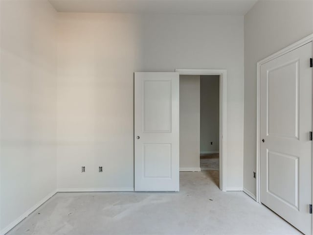 3305 NW 178th Ter, Edmond, OK 73012 - unfurnished bedroom featuring concrete flooring and baseboards