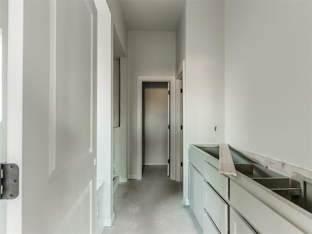 3305 NW 178th Ter, Edmond, OK 73012 - corridor featuring concrete floors and baseboards