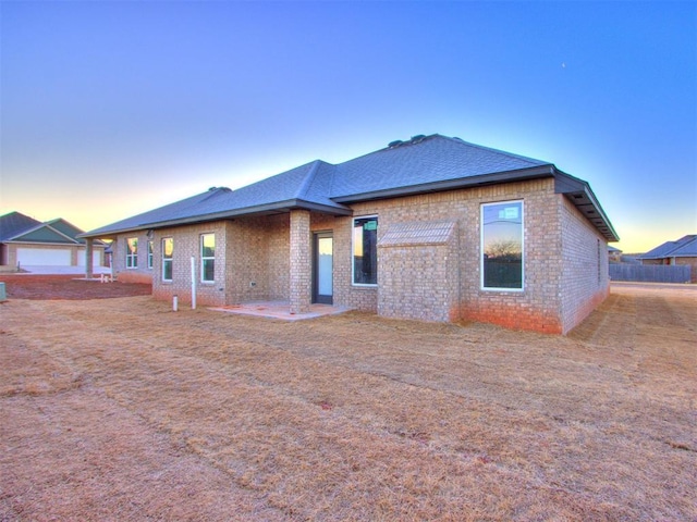 3305 NW 178th Ter, Edmond, OK 73012 - back of property at dusk with brick siding