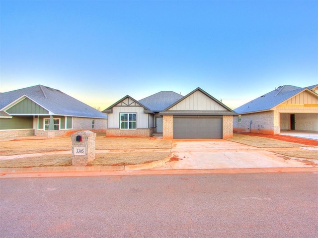 3305 NW 178th Ter, Edmond, OK 73012 - view of front of house with a garage, driveway, and board and batten siding