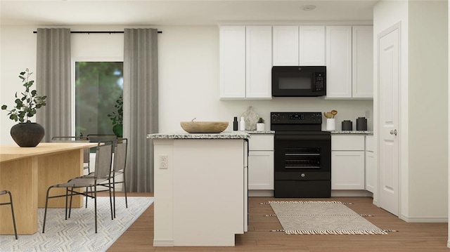 kitchen with light stone countertops, light wood-type flooring, black appliances, and white cabinetry