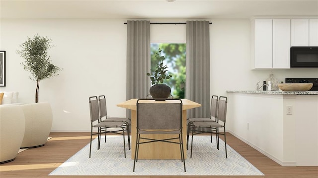 dining space featuring light wood-type flooring