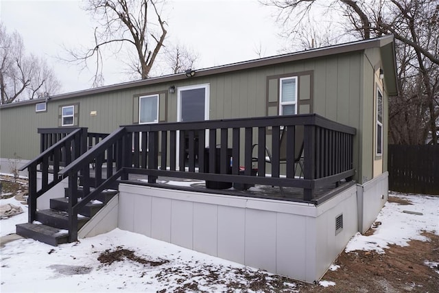 snow covered property featuring a wooden deck