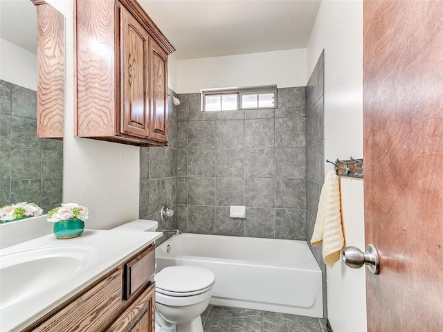 full bathroom with tiled shower / bath combo, vanity, and toilet