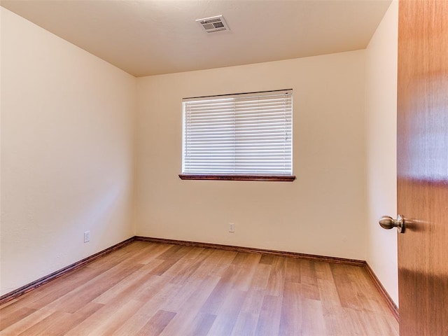 spare room with light hardwood / wood-style floors