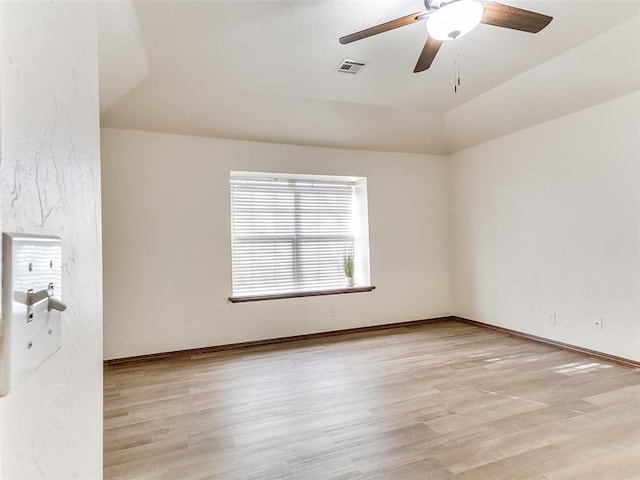 spare room with light hardwood / wood-style floors, ceiling fan, and vaulted ceiling