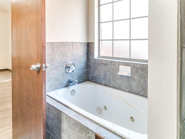 bathroom featuring tiled bath