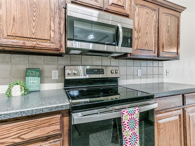 kitchen featuring stainless steel appliances, tile patterned floors, and tasteful backsplash