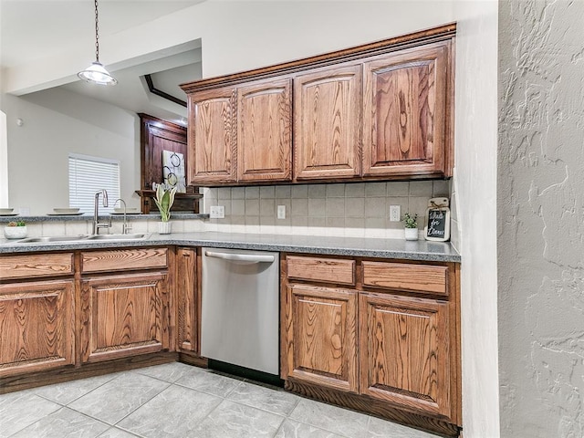 kitchen featuring dishwasher, hanging light fixtures, light tile patterned floors, decorative backsplash, and sink