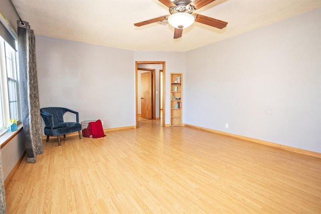 interior space featuring light wood-type flooring, ceiling fan, and a healthy amount of sunlight