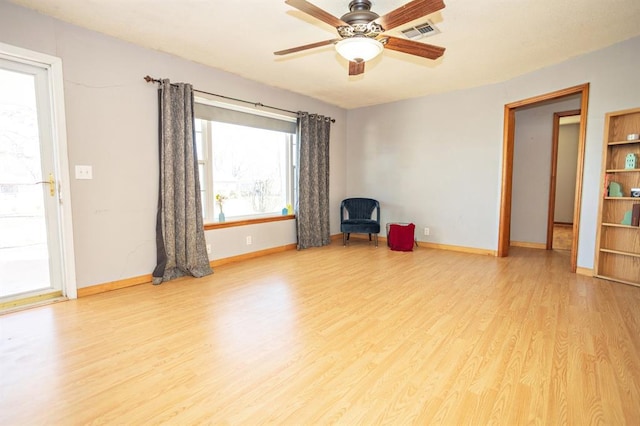 spare room with light wood-type flooring and ceiling fan