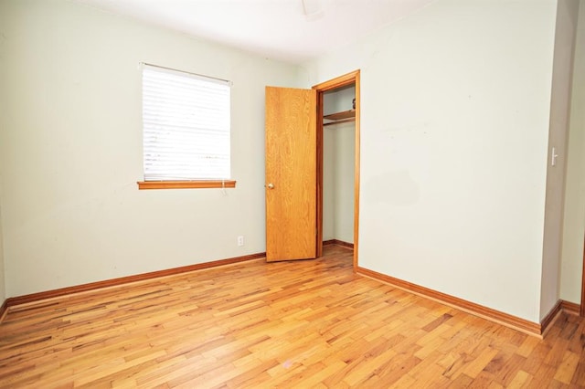 unfurnished bedroom featuring a closet and light wood-type flooring