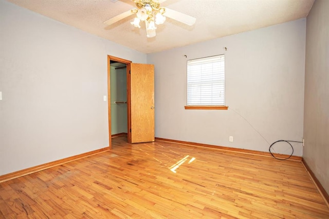 empty room featuring ceiling fan and light hardwood / wood-style floors