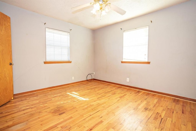 empty room featuring ceiling fan and light hardwood / wood-style flooring