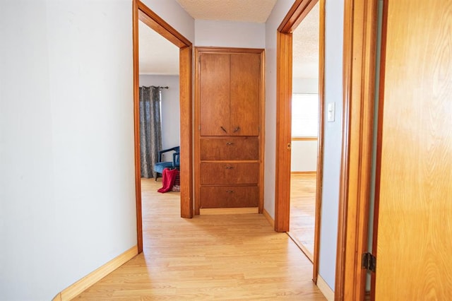 corridor with light hardwood / wood-style flooring