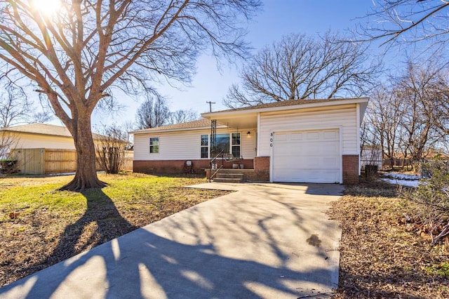 ranch-style house with a garage and a front lawn