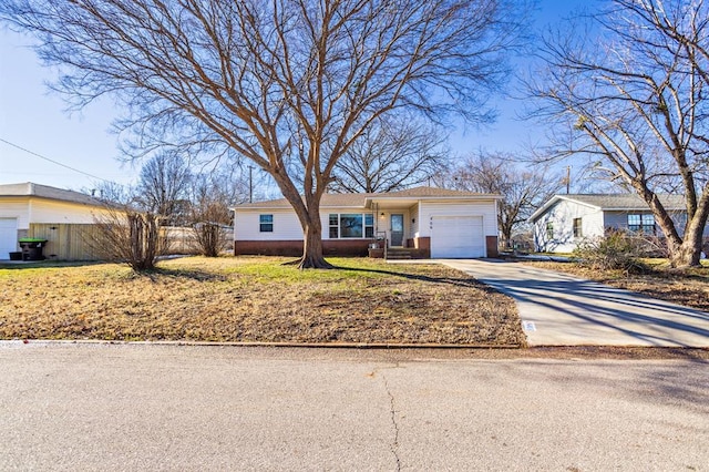 single story home with a front yard and a garage