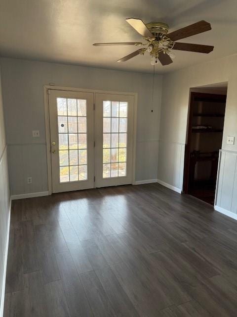 spare room featuring ceiling fan and dark wood-type flooring