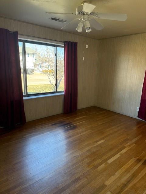 unfurnished room with ceiling fan and hardwood / wood-style floors