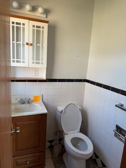 bathroom featuring tile walls, toilet, tile patterned floors, and vanity