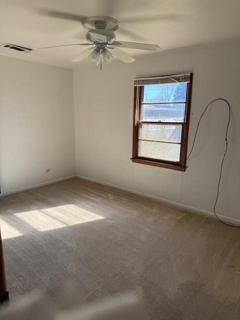 carpeted empty room with ceiling fan