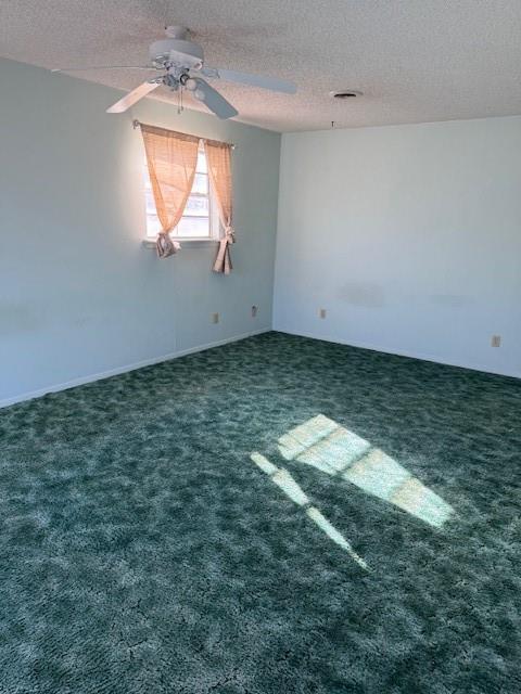 carpeted empty room with a textured ceiling and ceiling fan