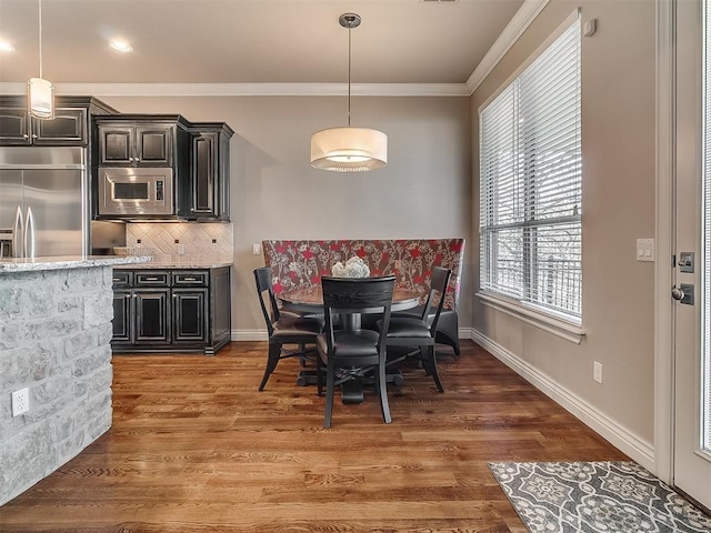 dining room with dark hardwood / wood-style flooring and ornamental molding