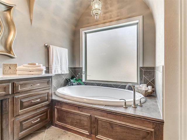 bathroom with a bath and tile patterned floors