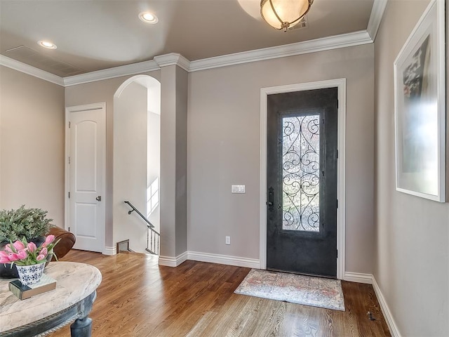 foyer entrance featuring hardwood / wood-style flooring and ornamental molding