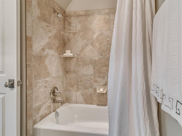 bathroom with shower / bath combo with shower curtain