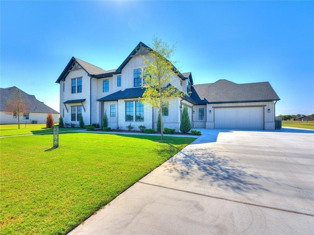 view of front of house featuring a garage and a front lawn