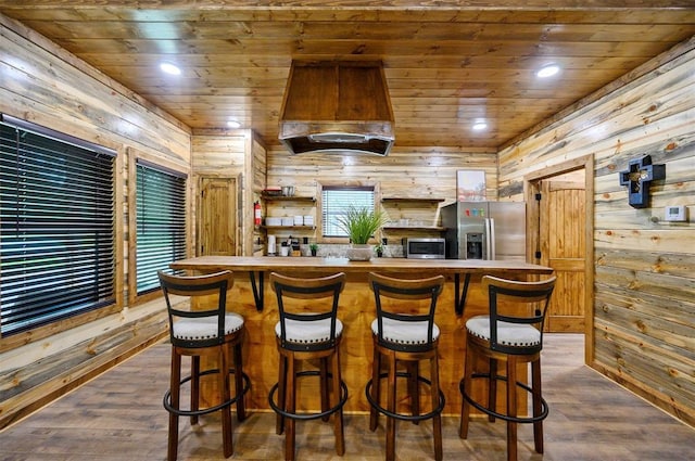 kitchen featuring appliances with stainless steel finishes, wooden ceiling, dark hardwood / wood-style floors, and custom range hood